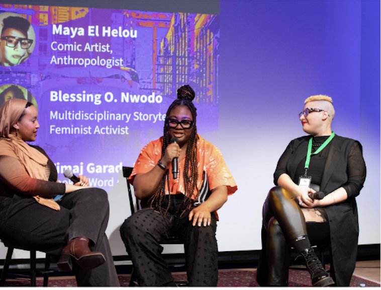 Maya El Helou on a panel discussion with two other speakers, seated in front of a screen reading "Maya El Helou, Comic Artist, Anthropologist."
